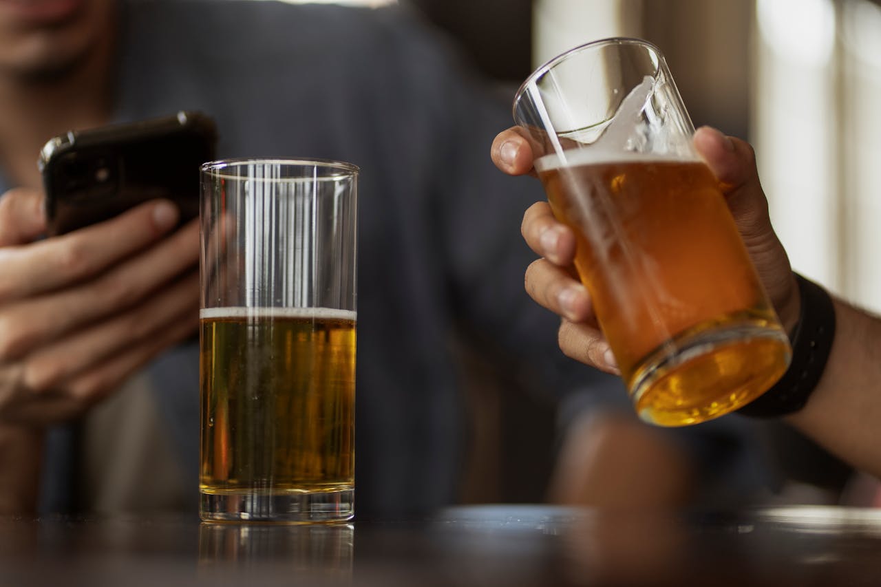 Two men enjoying cold beer in a relaxed pub atmosphere.